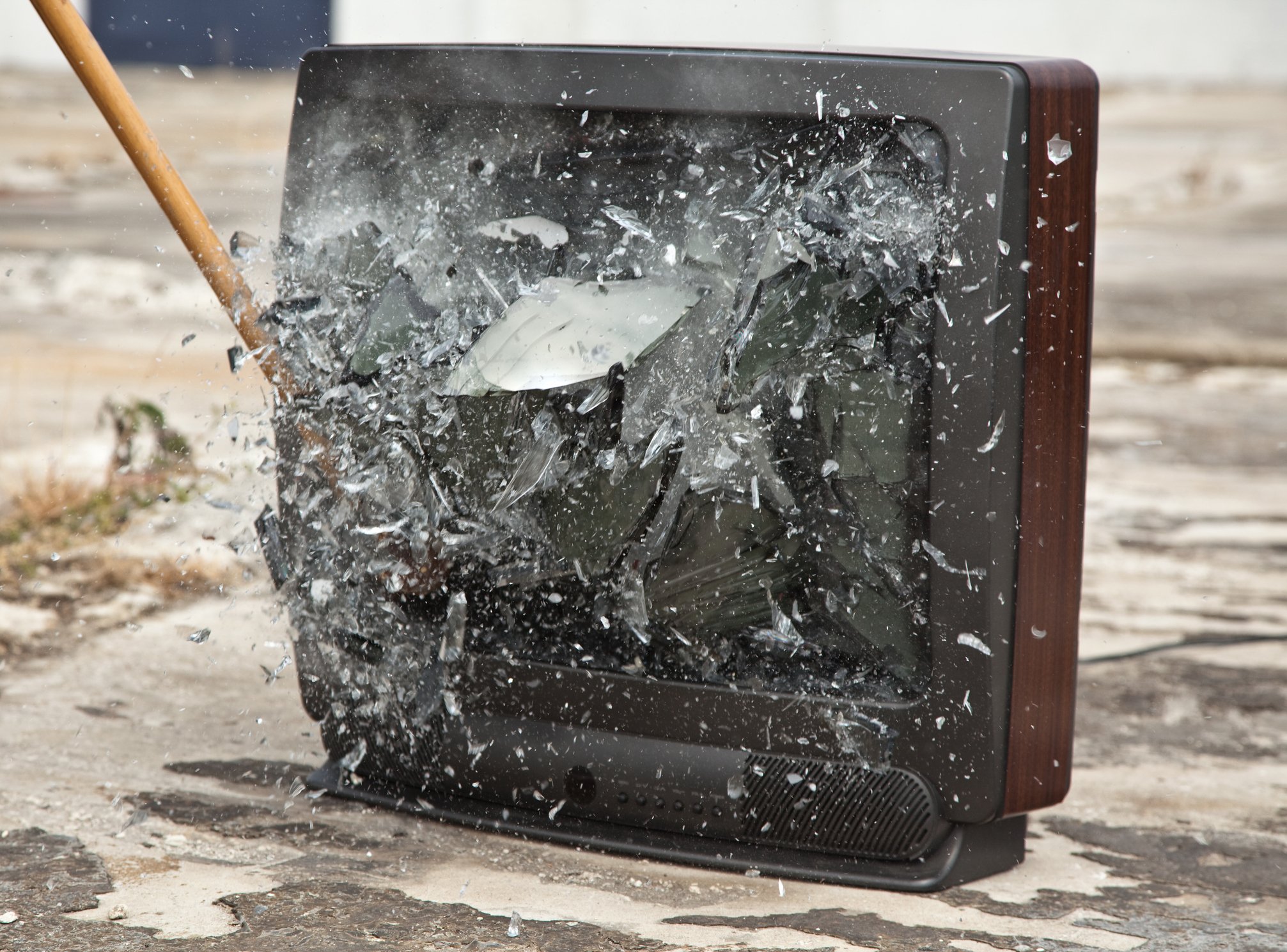 The screen of a TV set being smashed