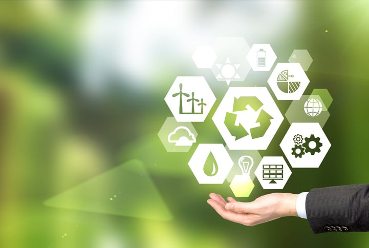 Renewable energy icons hovering over an outstretched hand.