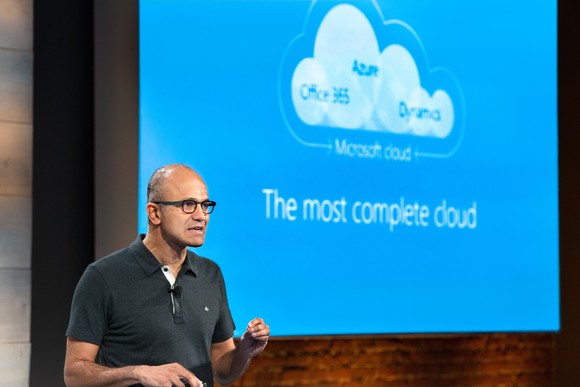 Satya Nadella in front of a presentation about Microsoft's "most complete cloud"