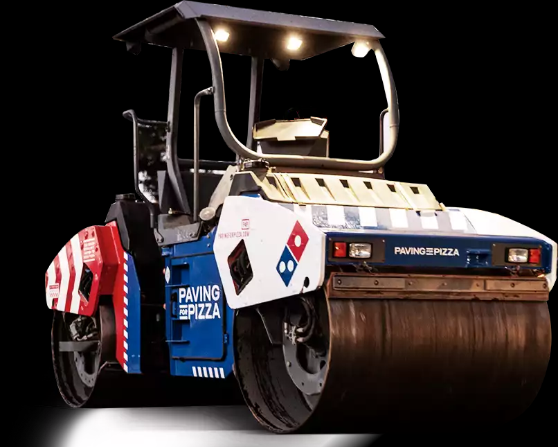 A steam roller painted in red white and blue with the Domino's Pizza logo on it.