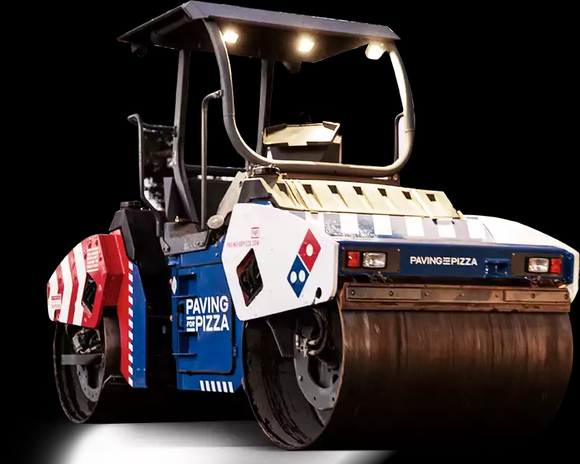 A steam roller painted in red white and blue with the Domino's Pizza logo on it.