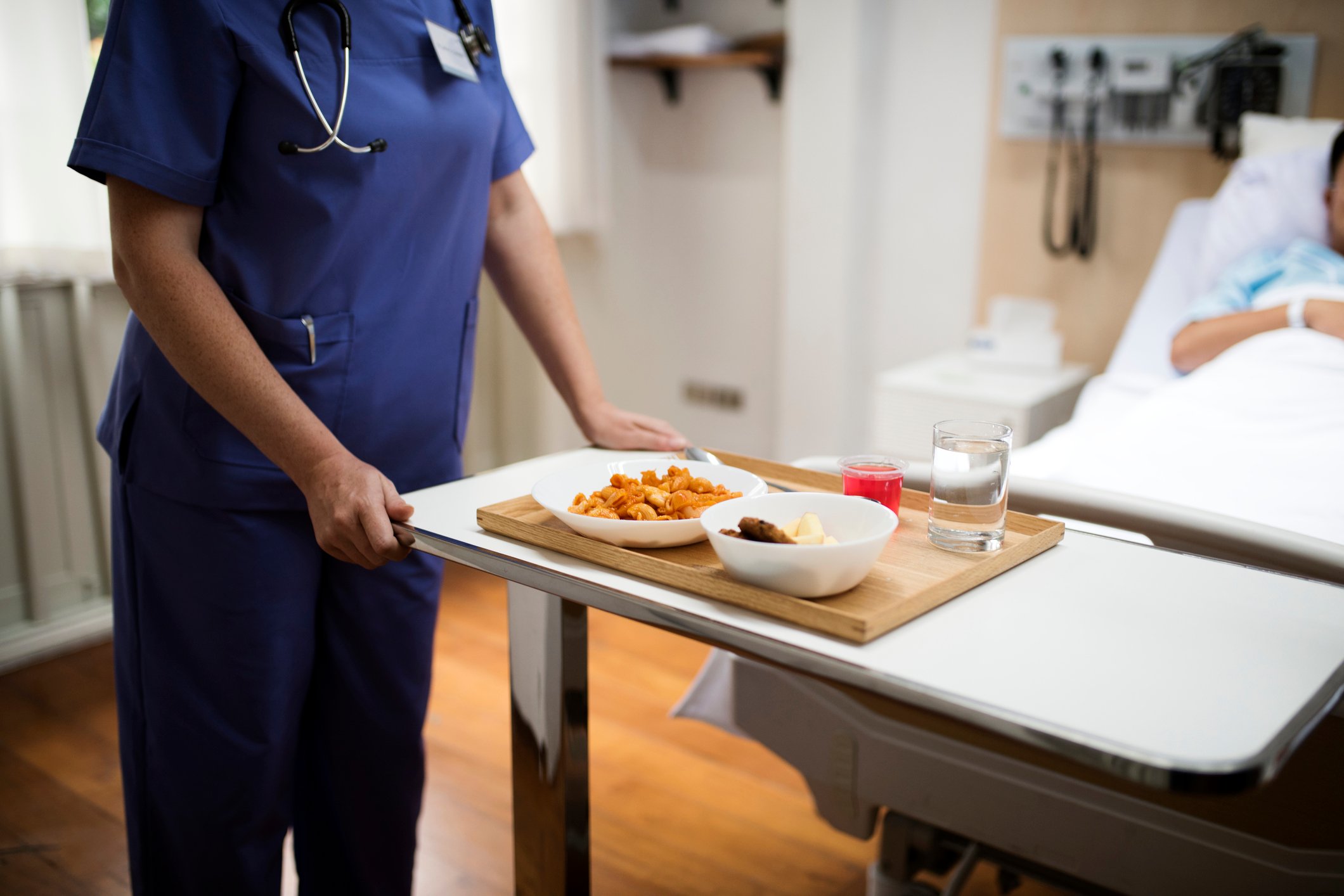 Nurse giving a patient a tray of food
