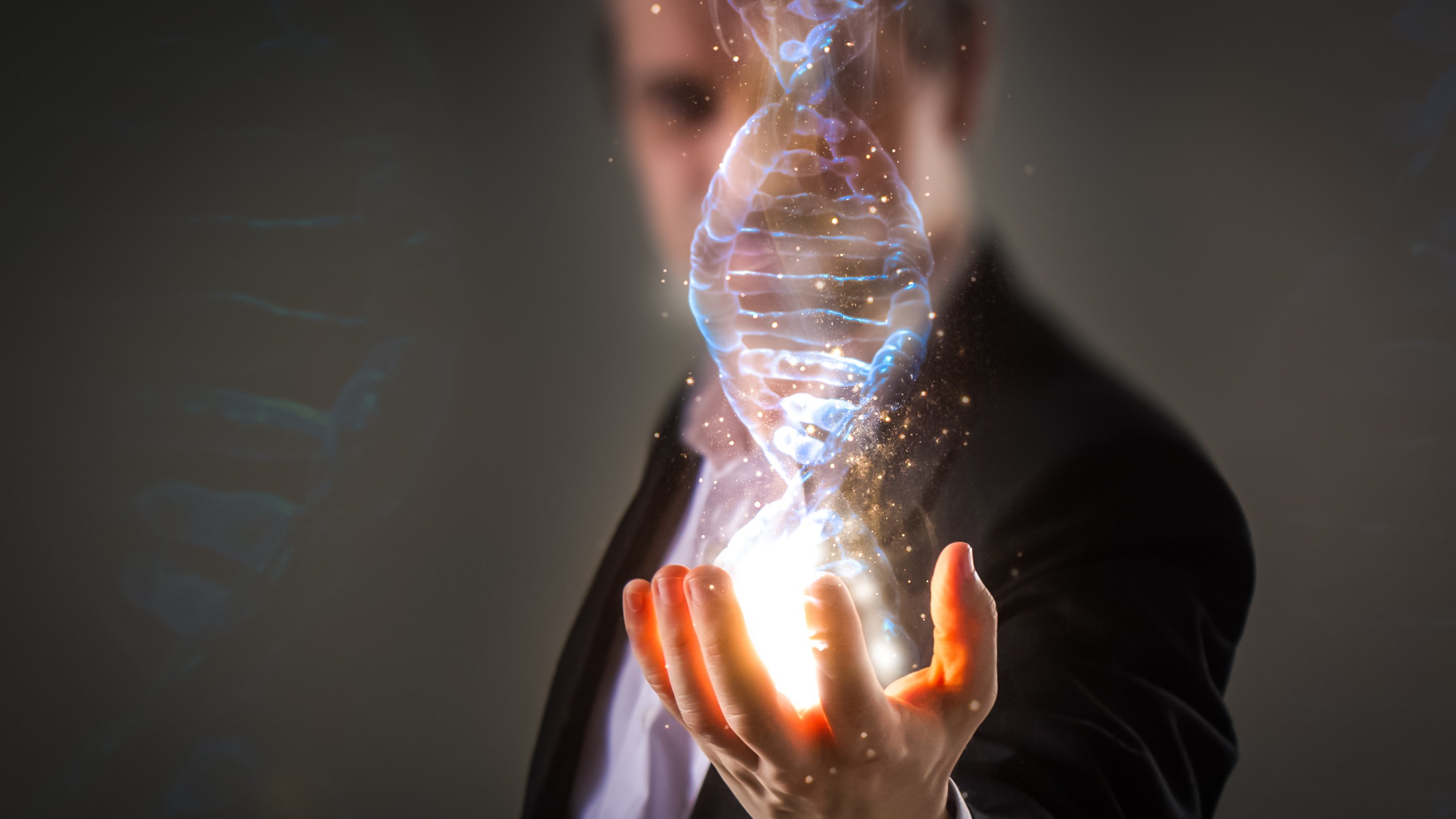 A man holding a holographic image of a DNA molecular in his outstretched hand.