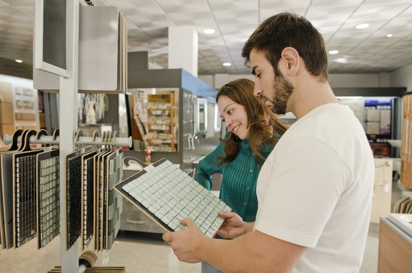 Young man and woman shopping in a tile store. 