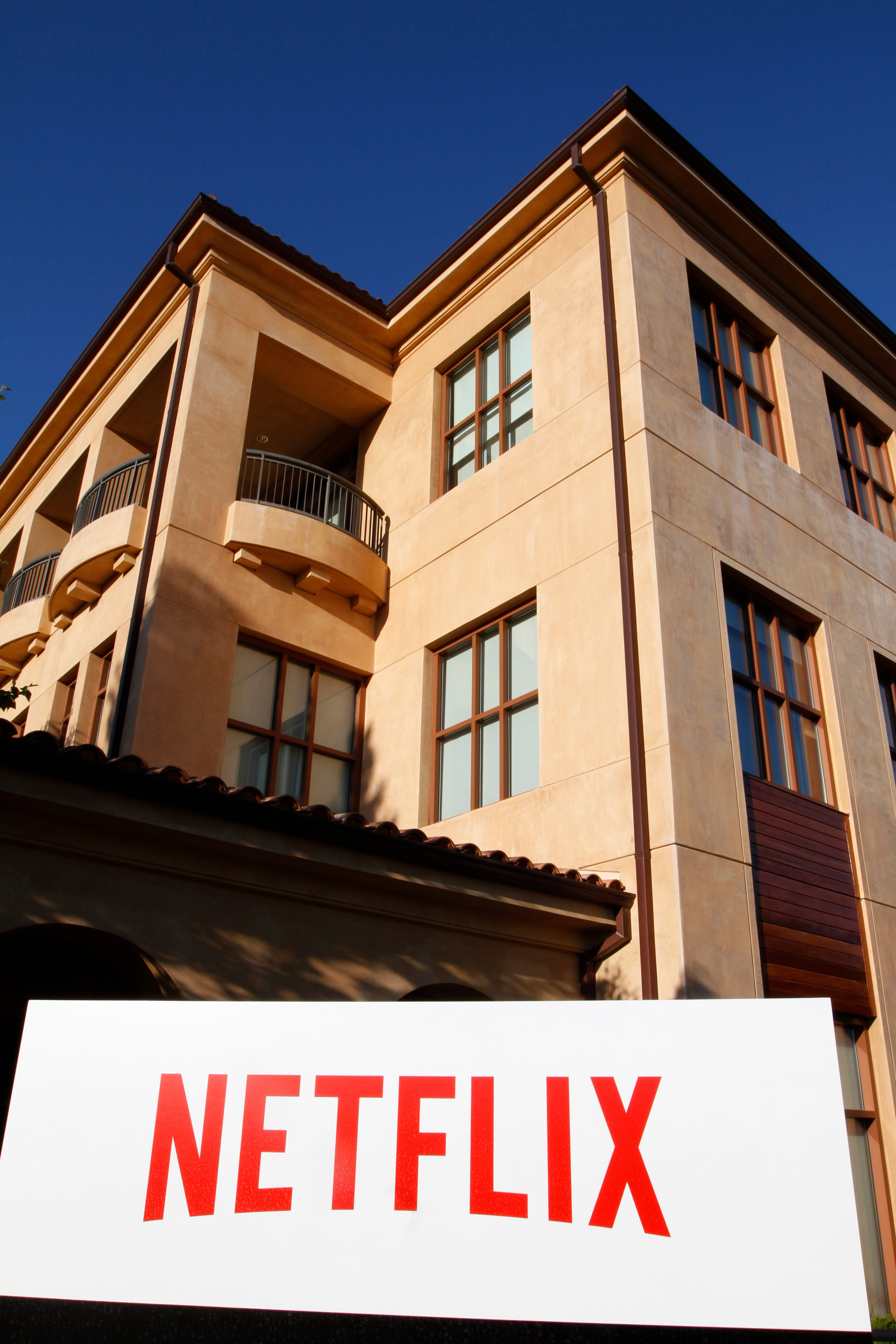 Photo of a building on Netflix's headquarters campus with the company name in red on a large, white sign.