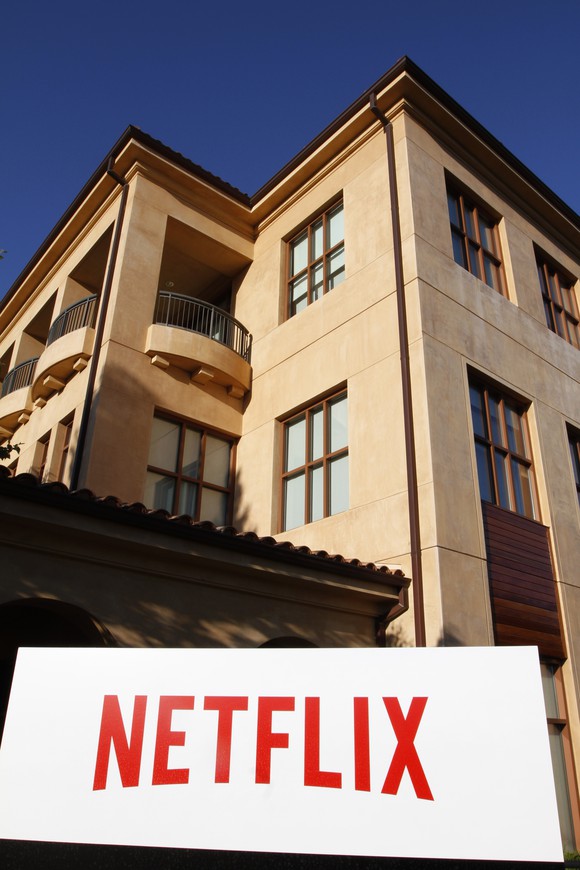Photo of a building on Netflix's headquarters campus with the company name in red on a large, white sign.