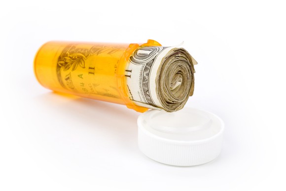 Pill bottle stuffed with dollars