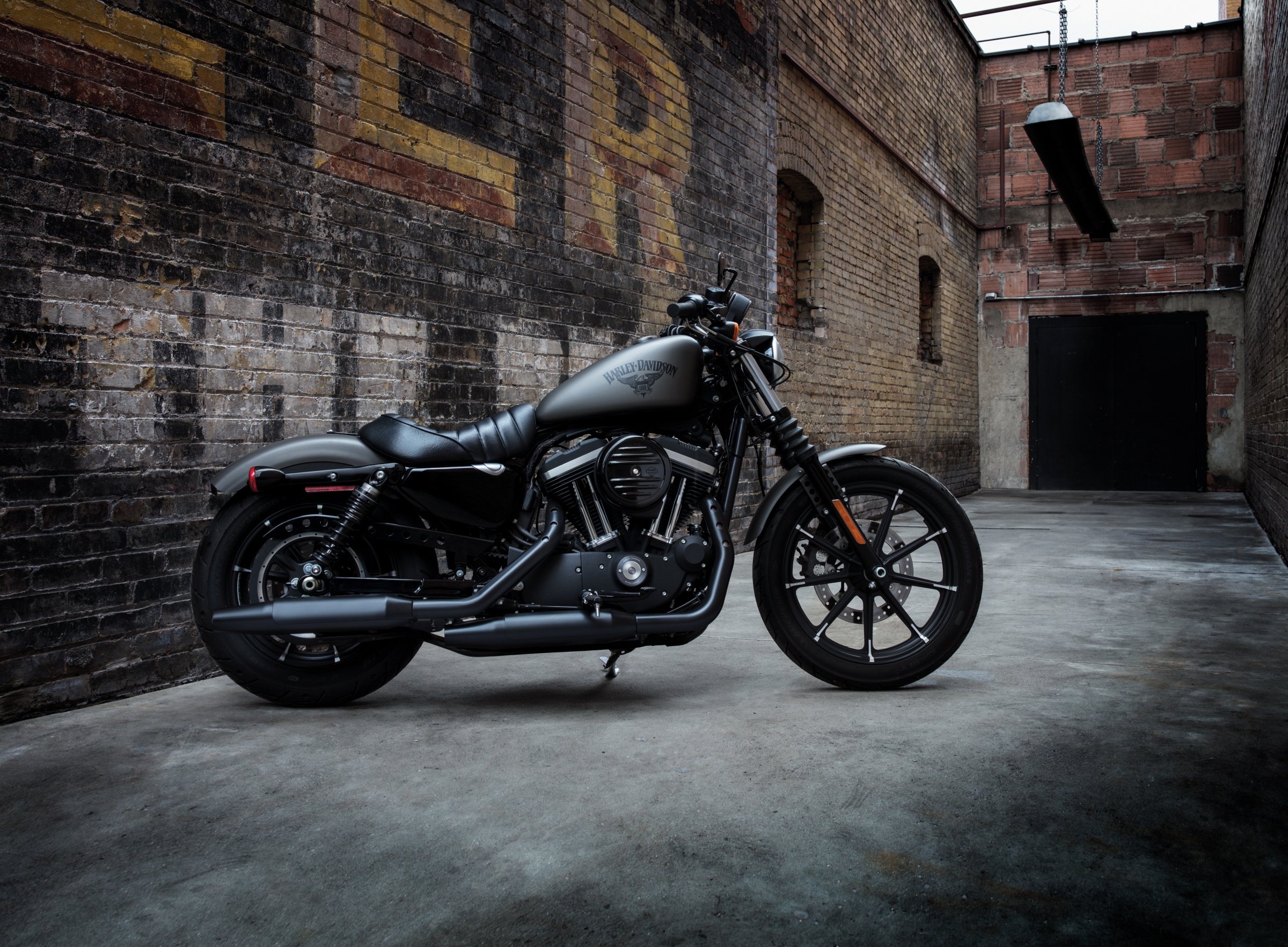 A Harley-Davidson motorcycle parked in an alley.