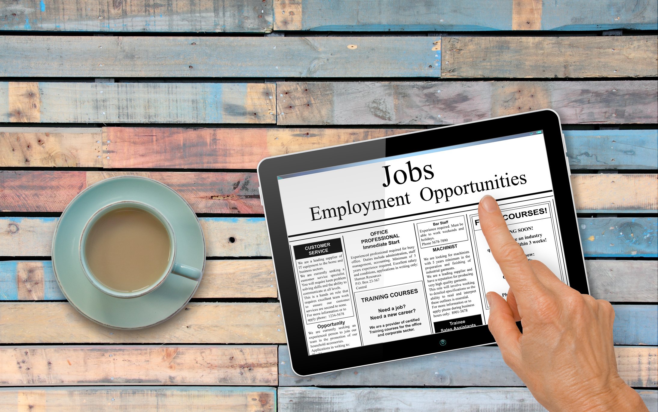 A tablet shows job listings.