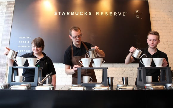 Baristas making coffee at Starbucks Reserve bar.