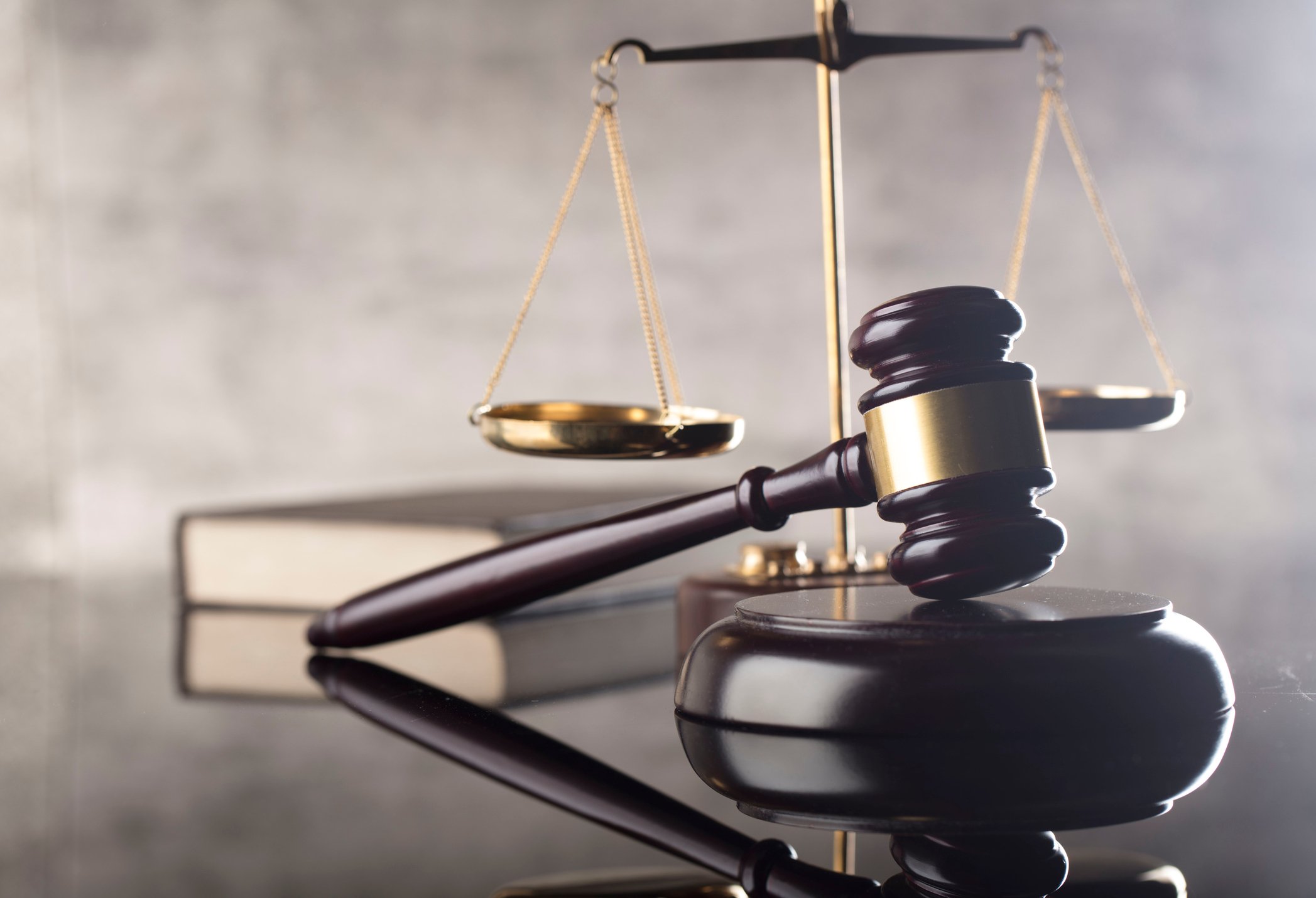 Gavel and hammer with scales in background