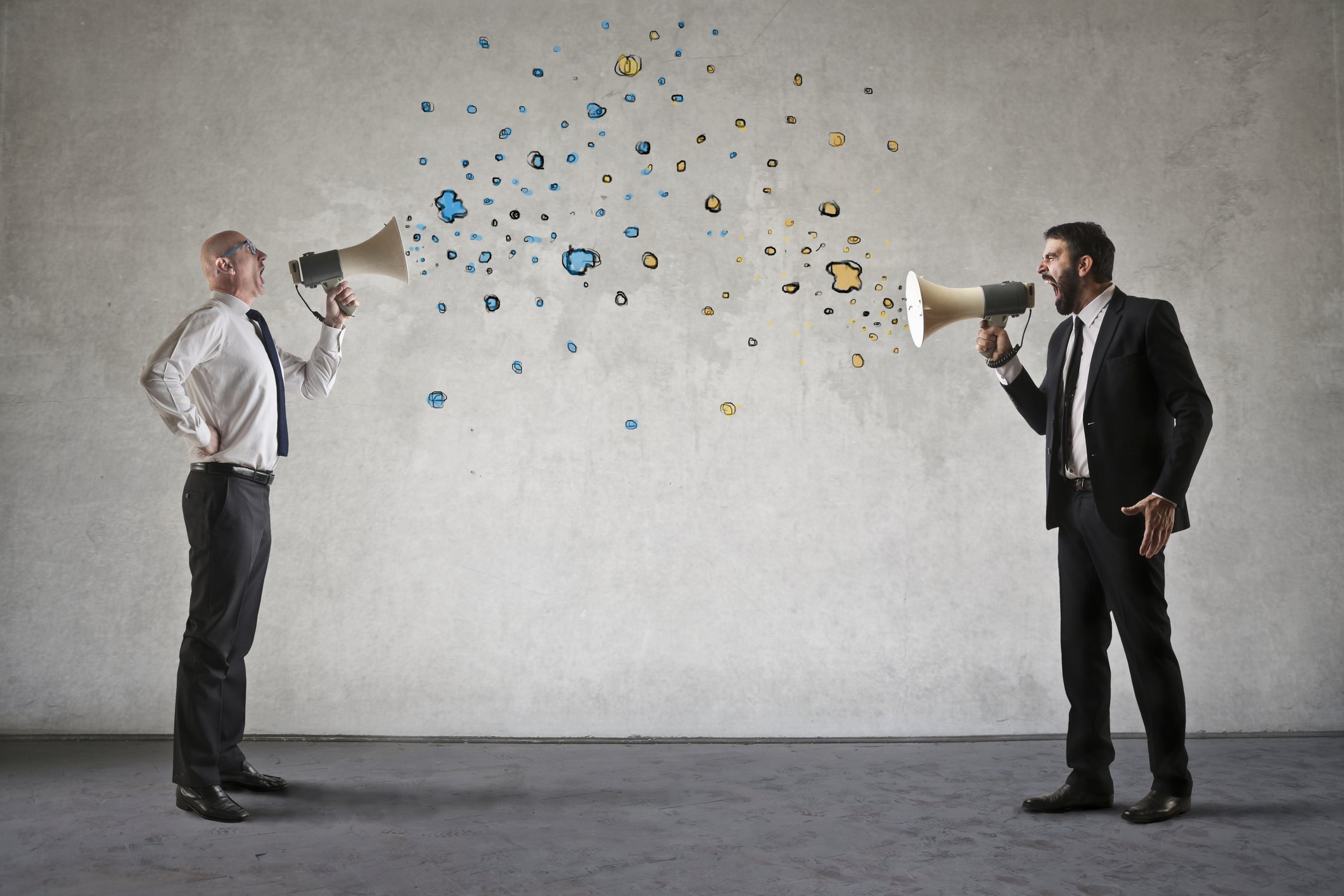 Men are screaming into megaphones