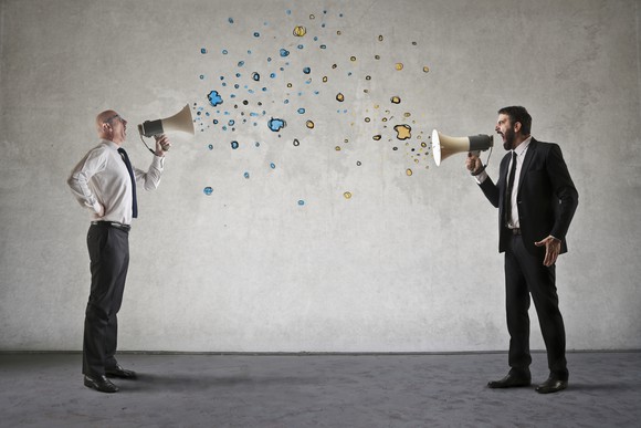 Men are screaming into megaphones