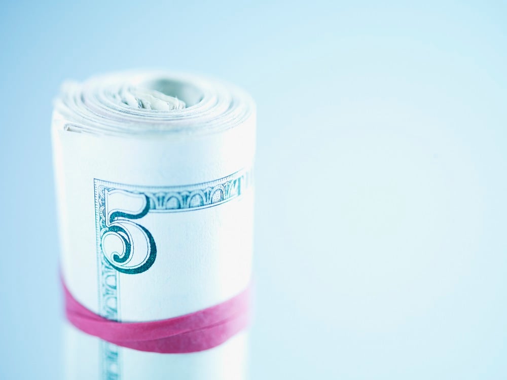 Five dollar bills wrapped in a rubber band.