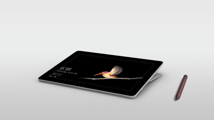 A Microsoft Surface Go against a white background with a stylus next to it.