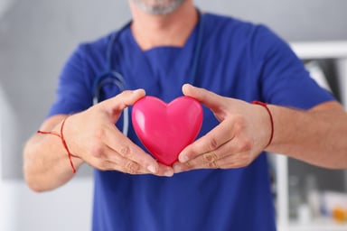 Doctor holding a heart symbol in his hands