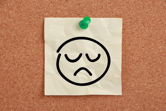 Drawing of sad face pinned to board