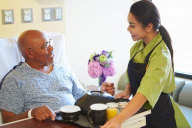 WOrker providing patient with food