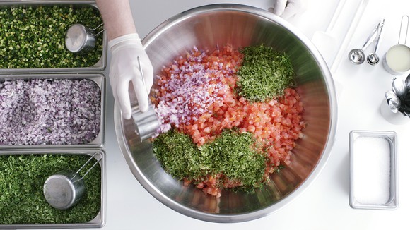 View of hand making salsa.