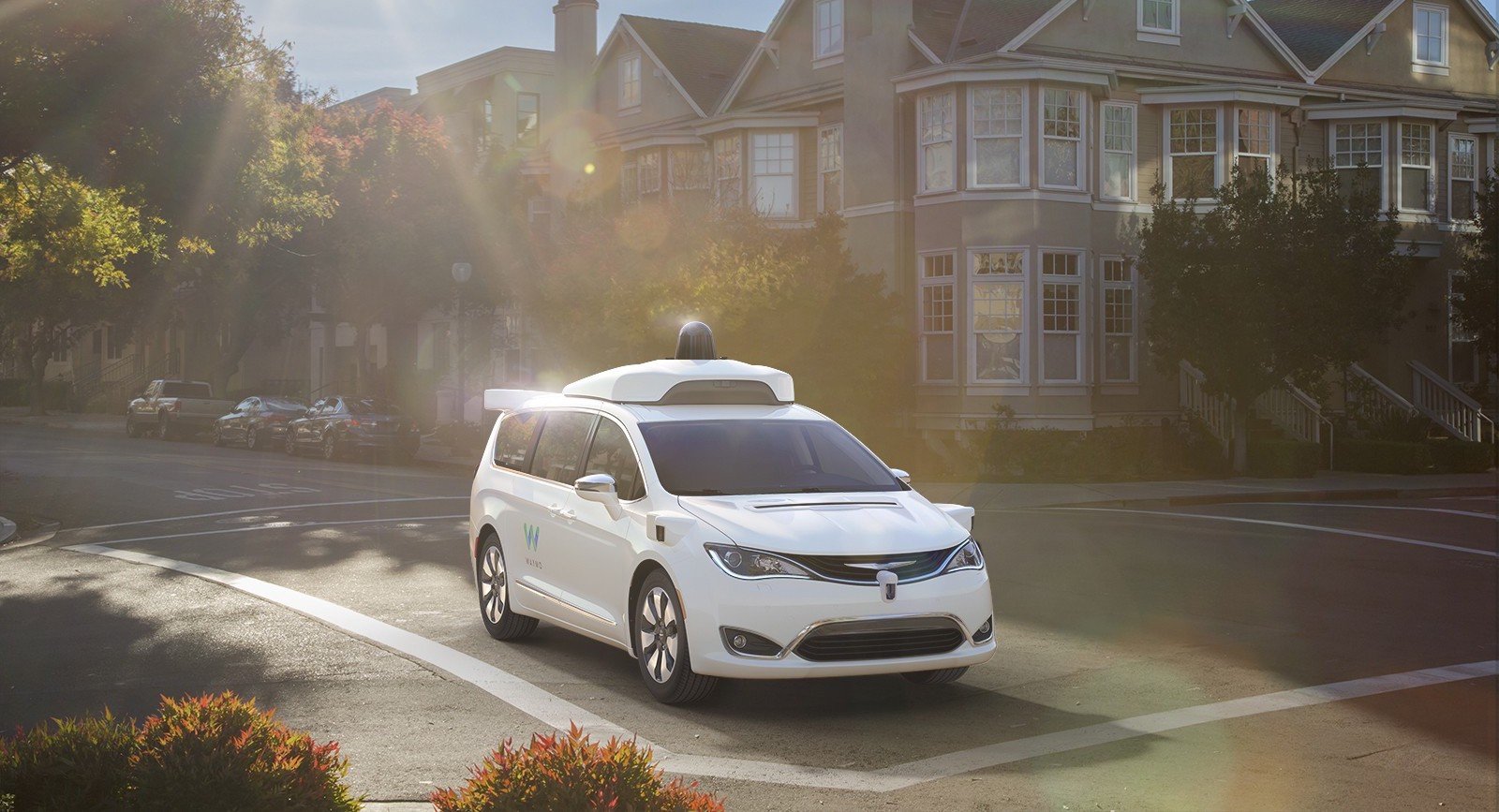 Image of Waymo minivan on street.