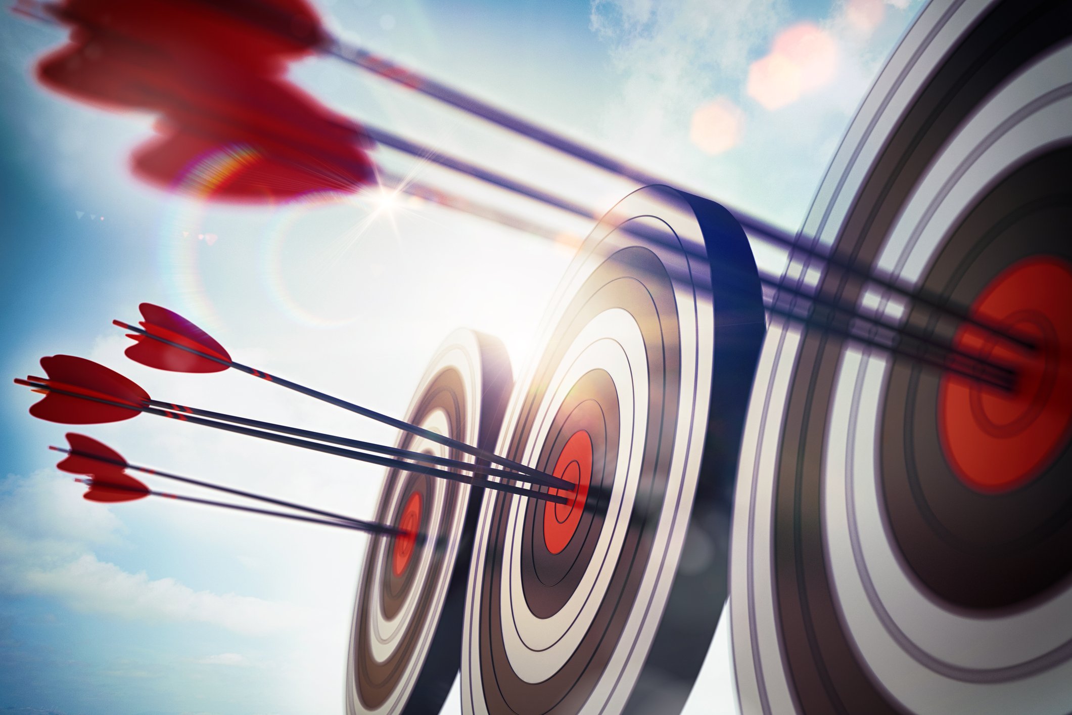 Arrows hitting bull's-eye on three targets