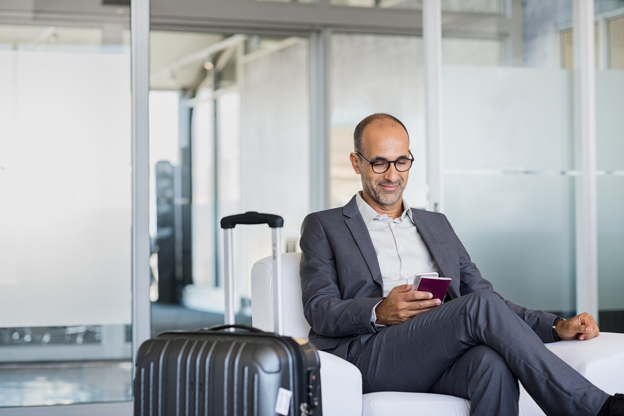 Man seated in airport lounge.