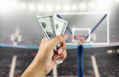 Person Holding Money on Basketball Court