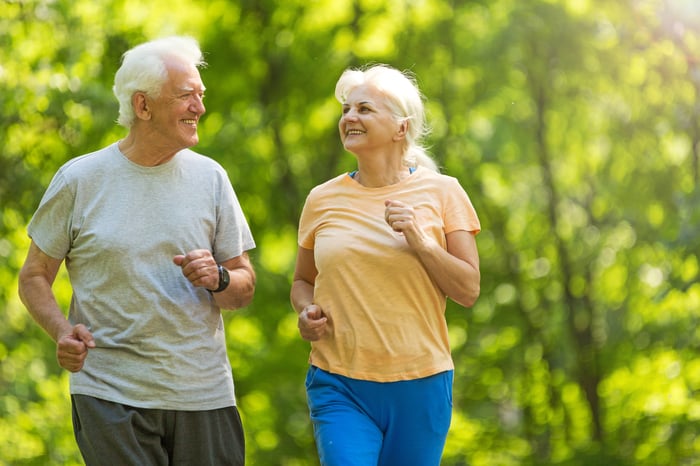 Smiling senior couple out for a jog.
