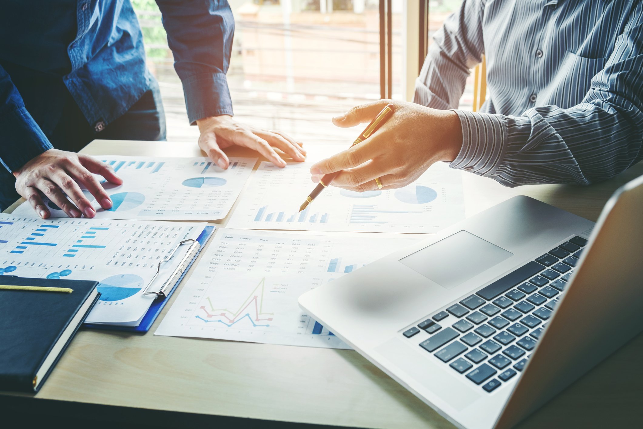 Two people analyze a company's finances in an office setting.