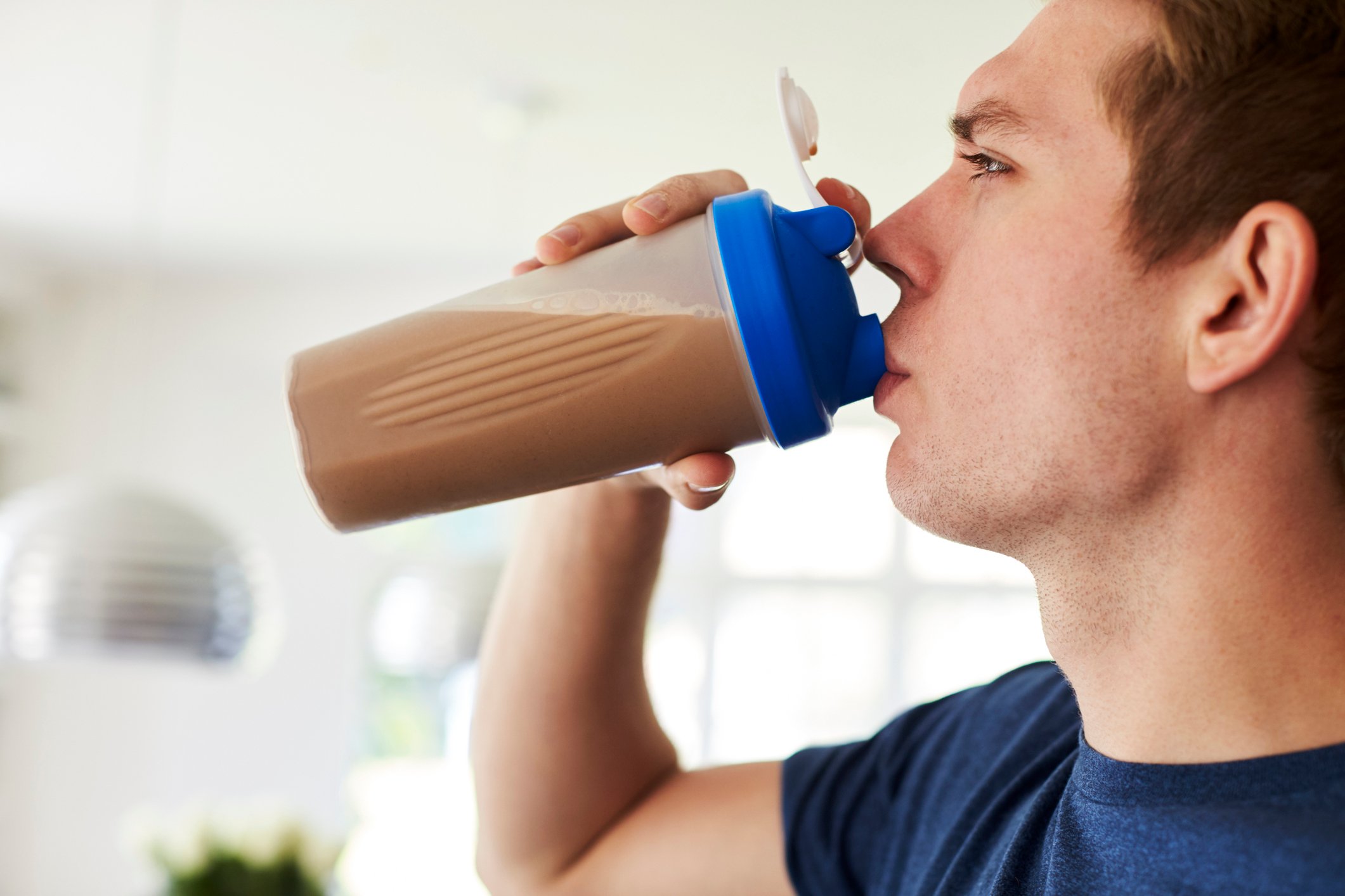 Man drinking a protein or nutritional shake.