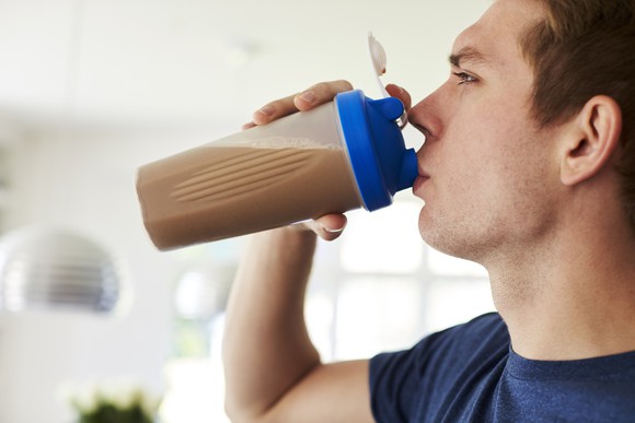 Man drinking a protein or nutritional shake.
