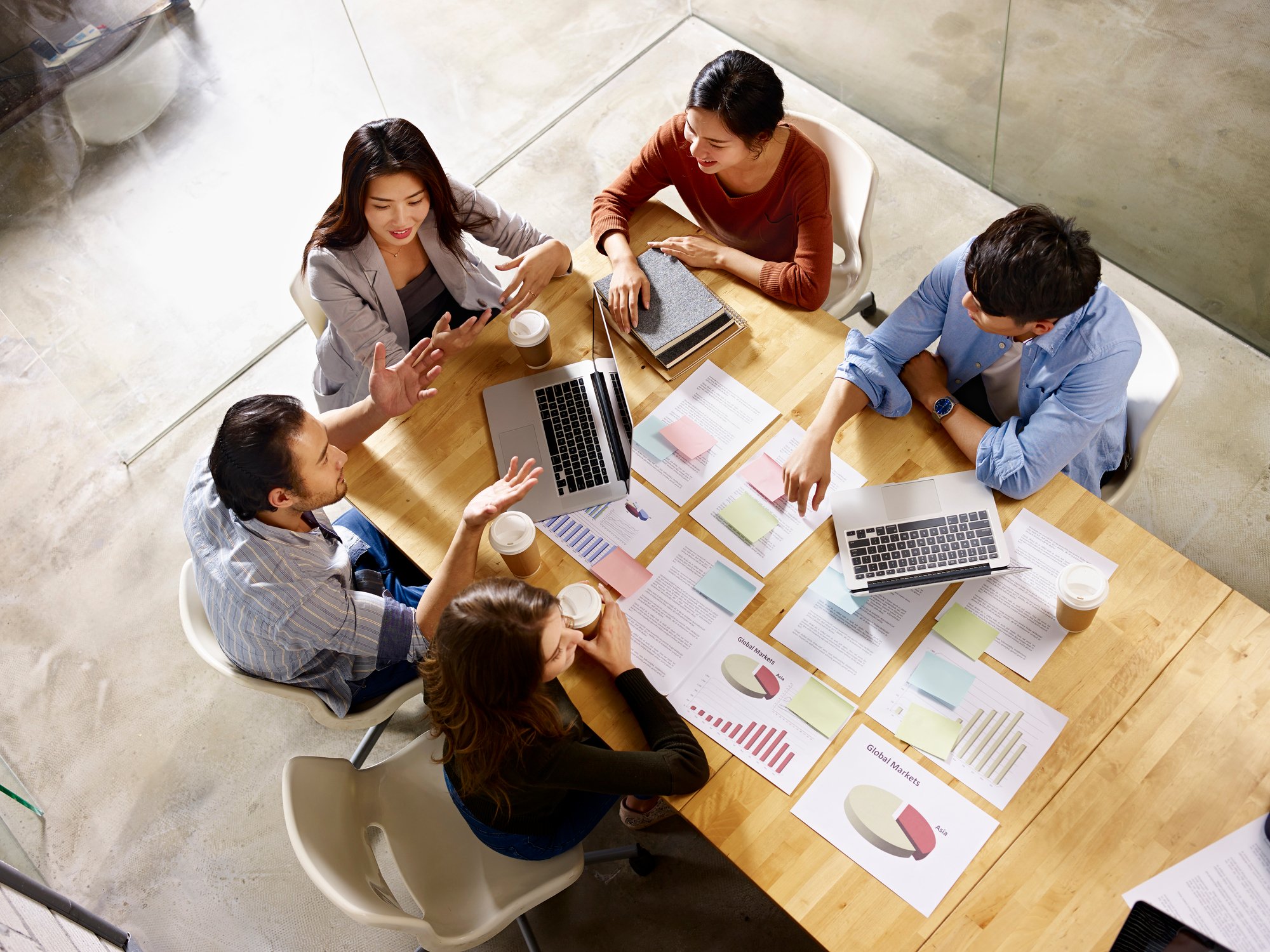 Workers sit around a table.