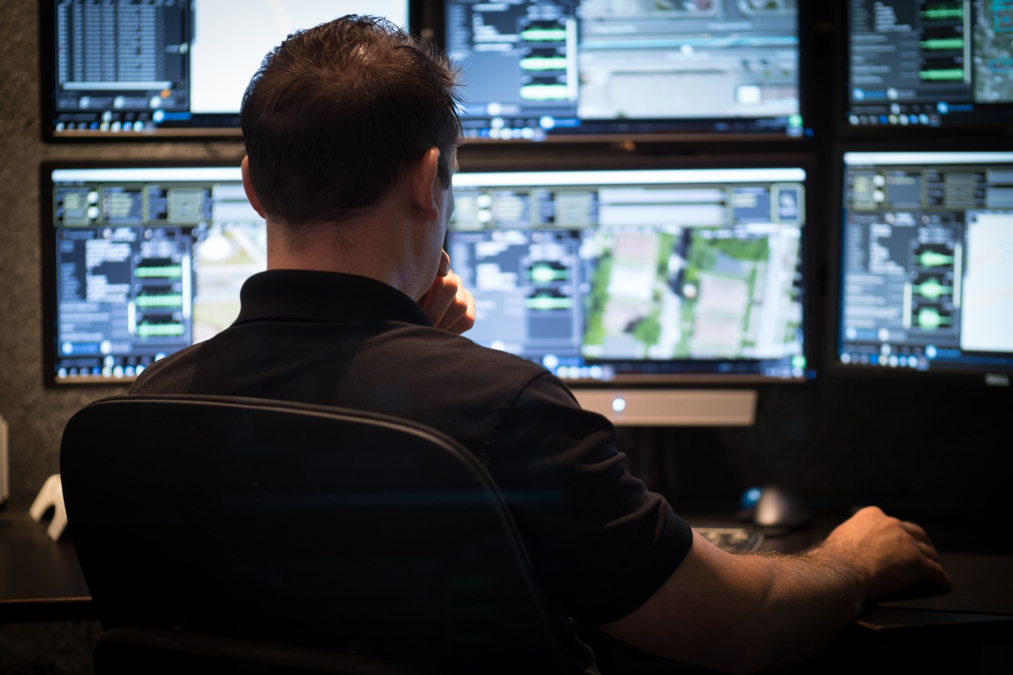 ShotSpotter employee looking at computer monitors.