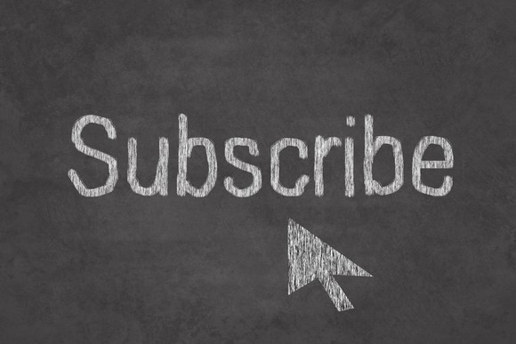 The word "subscribe" on a chalkboard