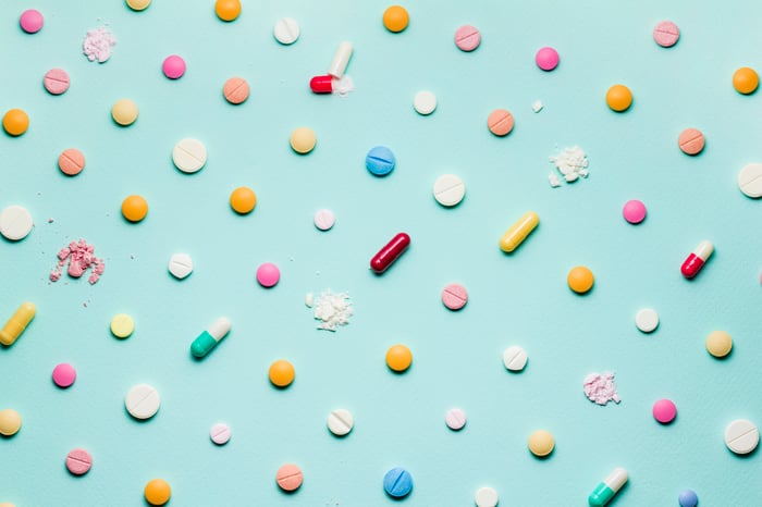 Many different types of pills on a blue background