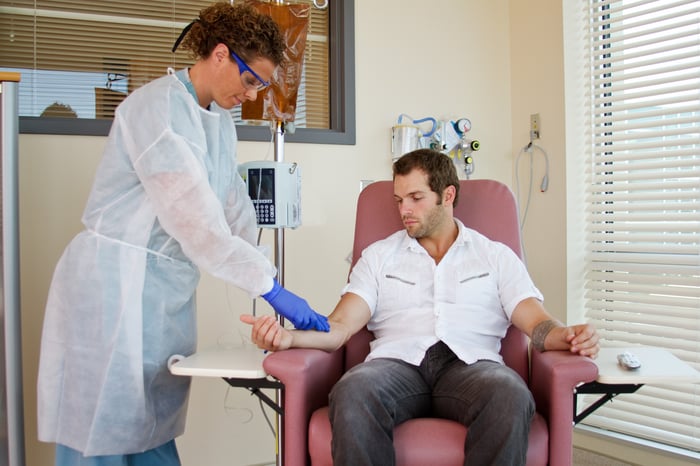 Technician giving a patient an infusion