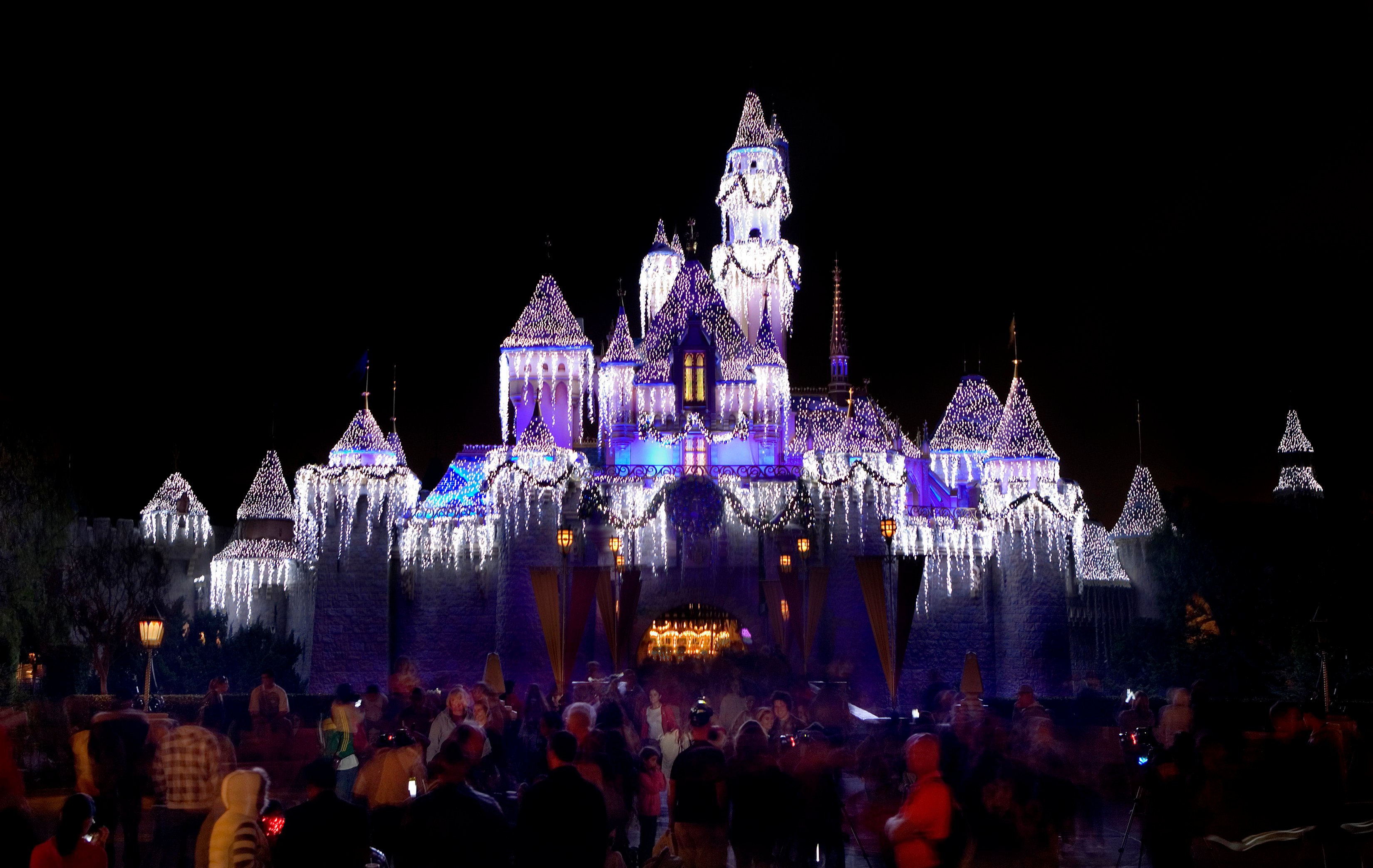 Disneyland's Sleeping Beauty Castle lit up at night.