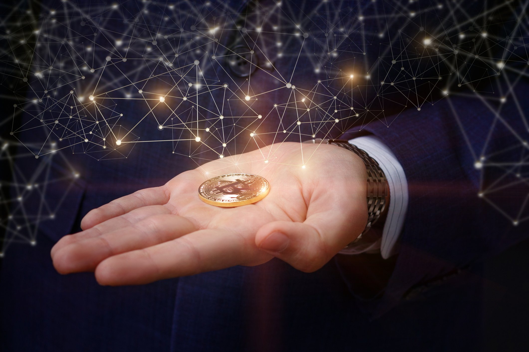 Gold token in outstretched palm.