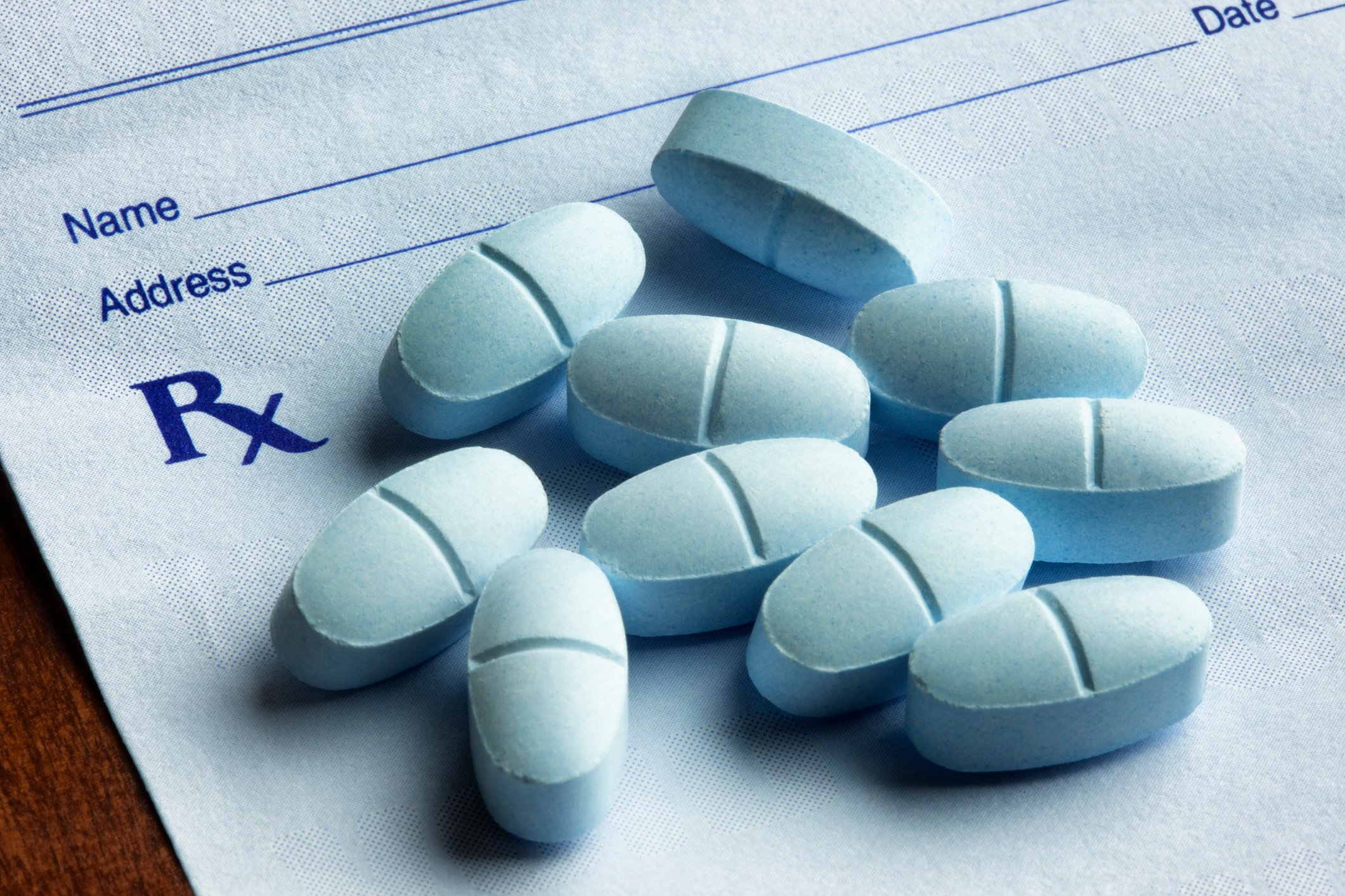 Ten light-blue pills on prescription pad