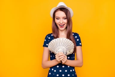 Excited girl with money and summer dress