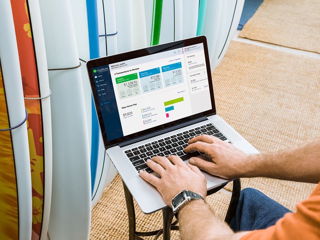 A small business owner using Intuit's QuickBooks Online on a laptop