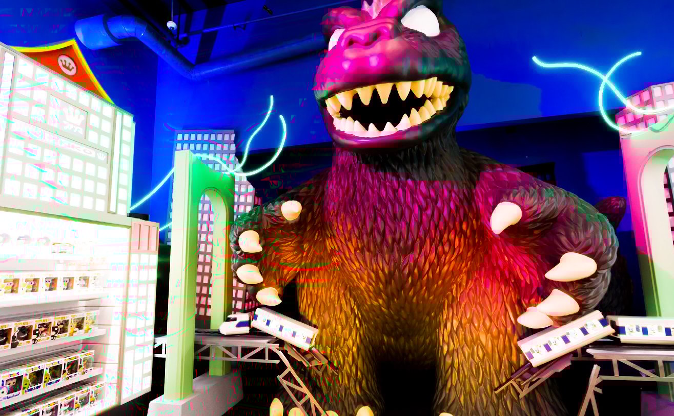 Funko product display beside life-sized Godzilla figure in Funko headquarters.