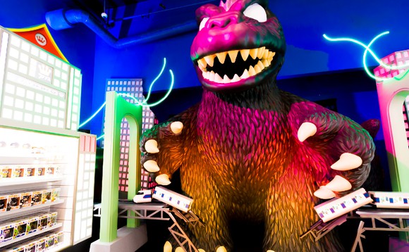 Funko product display beside life-sized Godzilla figure in Funko headquarters.