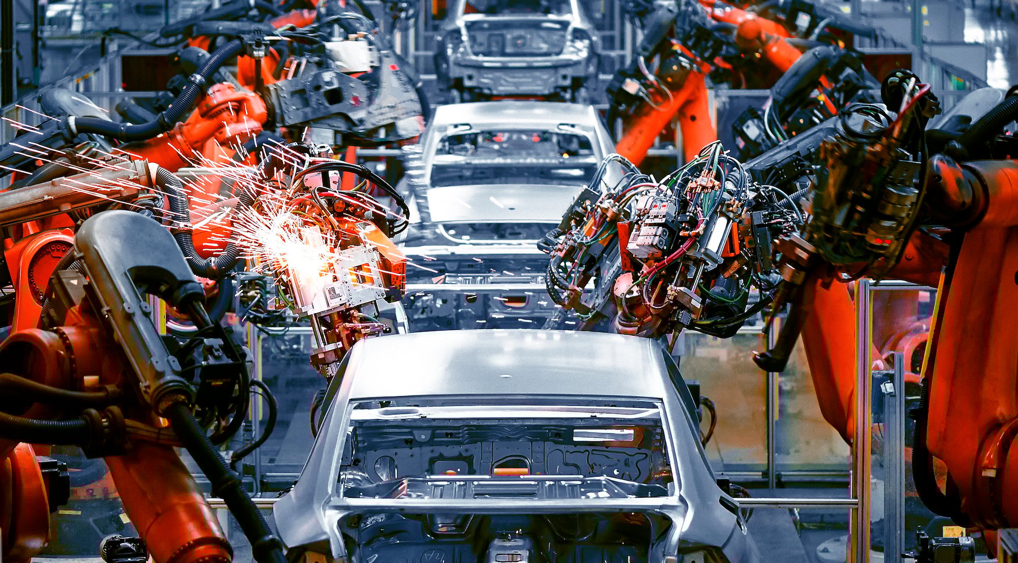 Cars on an assembly line.