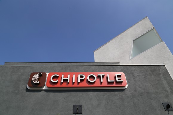 The exterior of a Chipotle restaurant, showing the brand's logo.