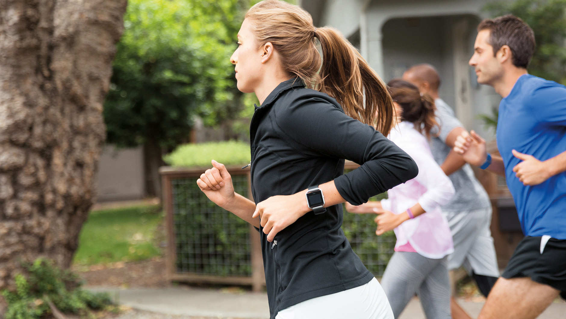 Woman jogging wearing a Fitbit Blaze