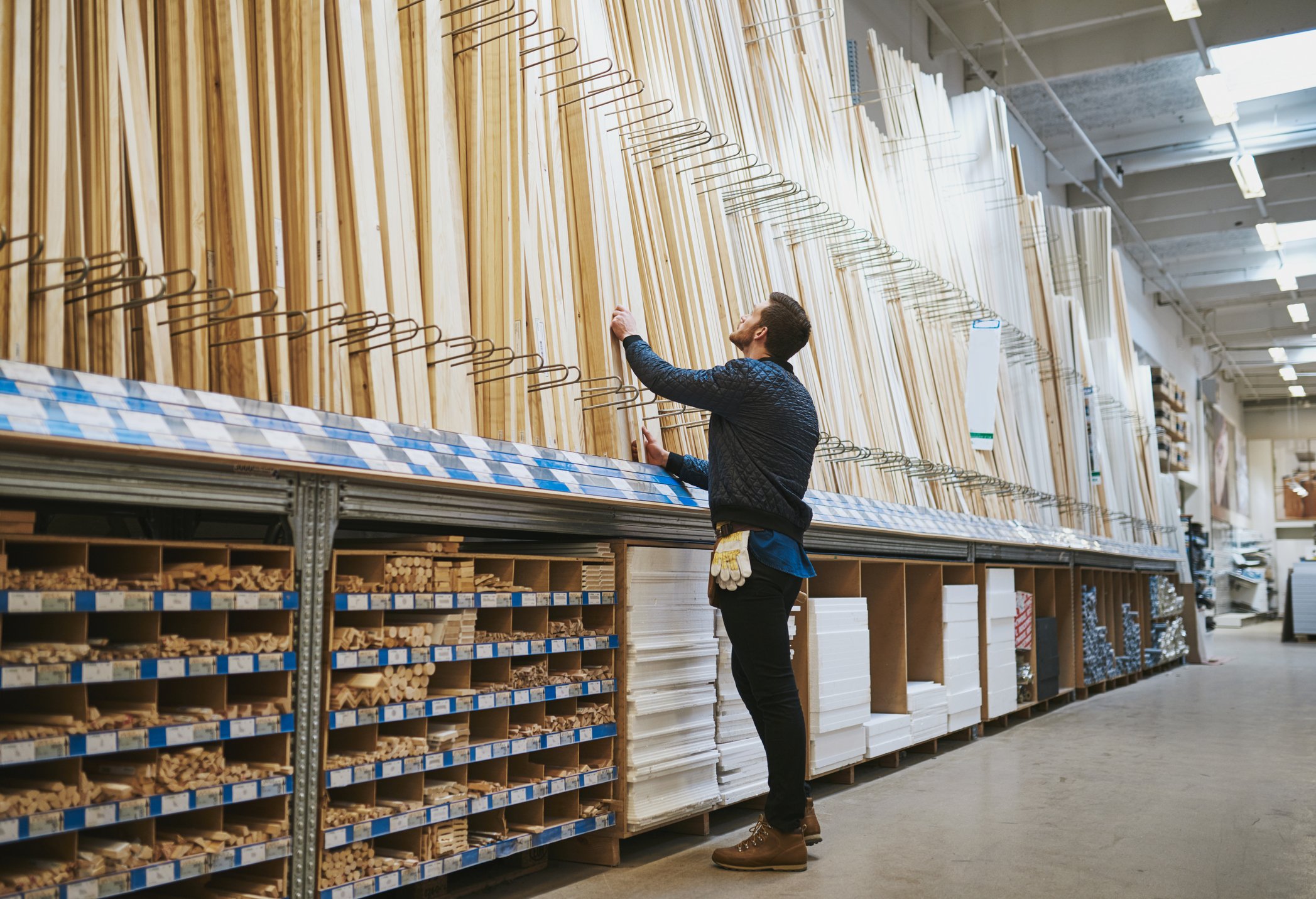 A man browsed wood in a home improvement store.