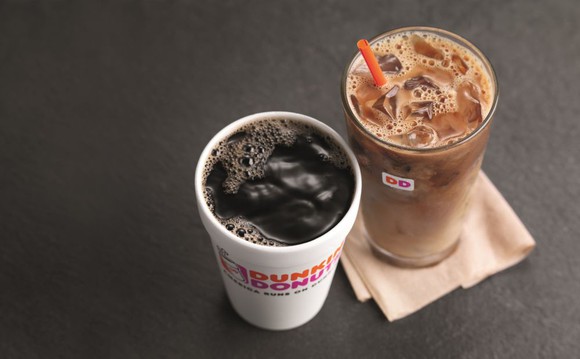 A cup of hot black coffee beside a glass of iced coffee.