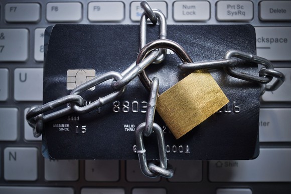 Credit card wrapped in chains with padlock