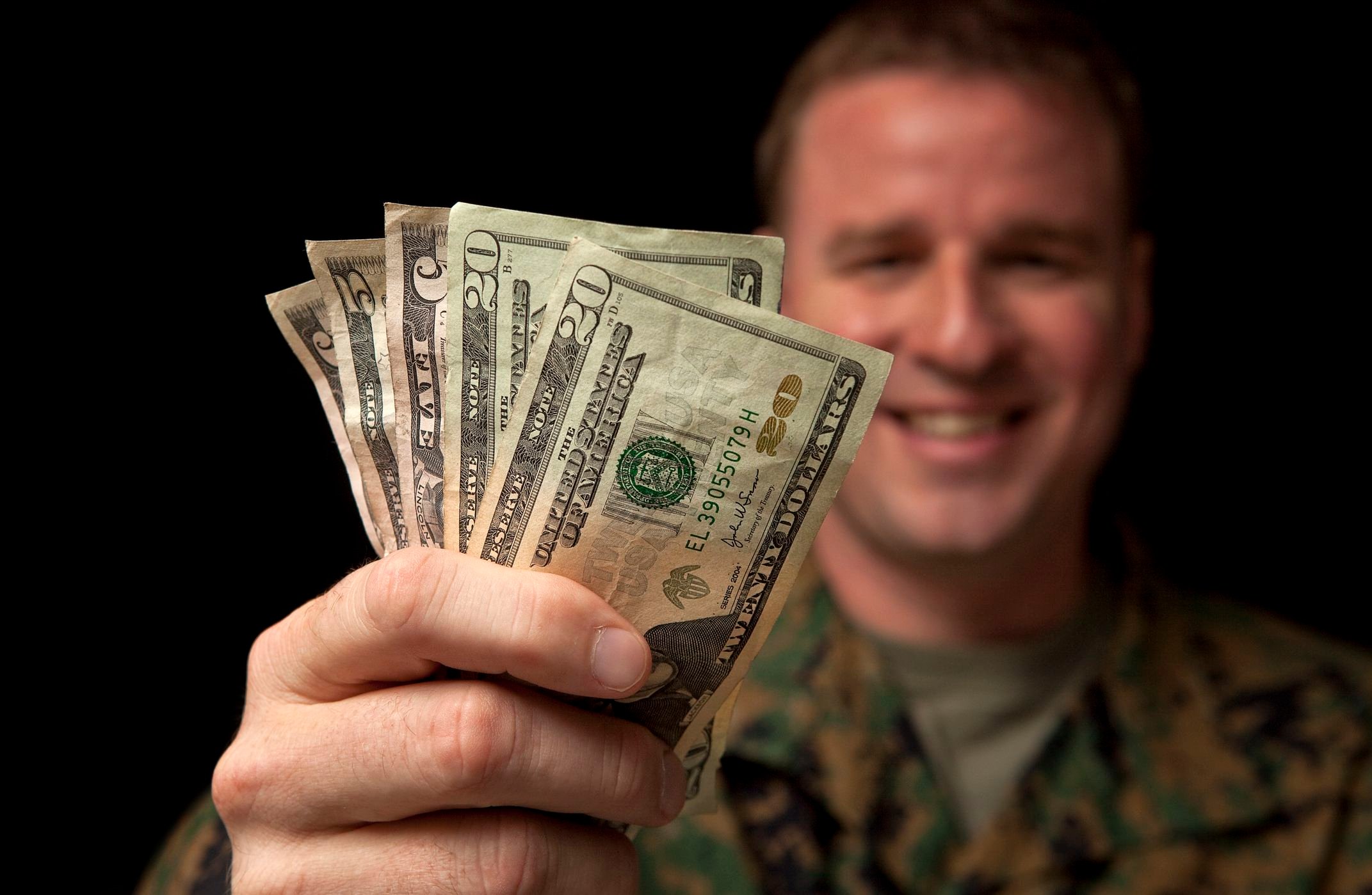 Military member holding cash